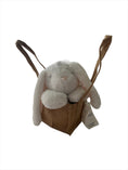 Load image into Gallery viewer, Vanilla ice cream coloured fluffy plush bunny head resting adorably on its paws, sitting propped up in a natural, brown hessian jute bag
