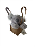 Load image into Gallery viewer, Peaceful, adorable stormy-grey cloud coloured, plush Koala head with white fluffy ears sitting resting with its paws, propped up in a natural, brown hessian jute bag
