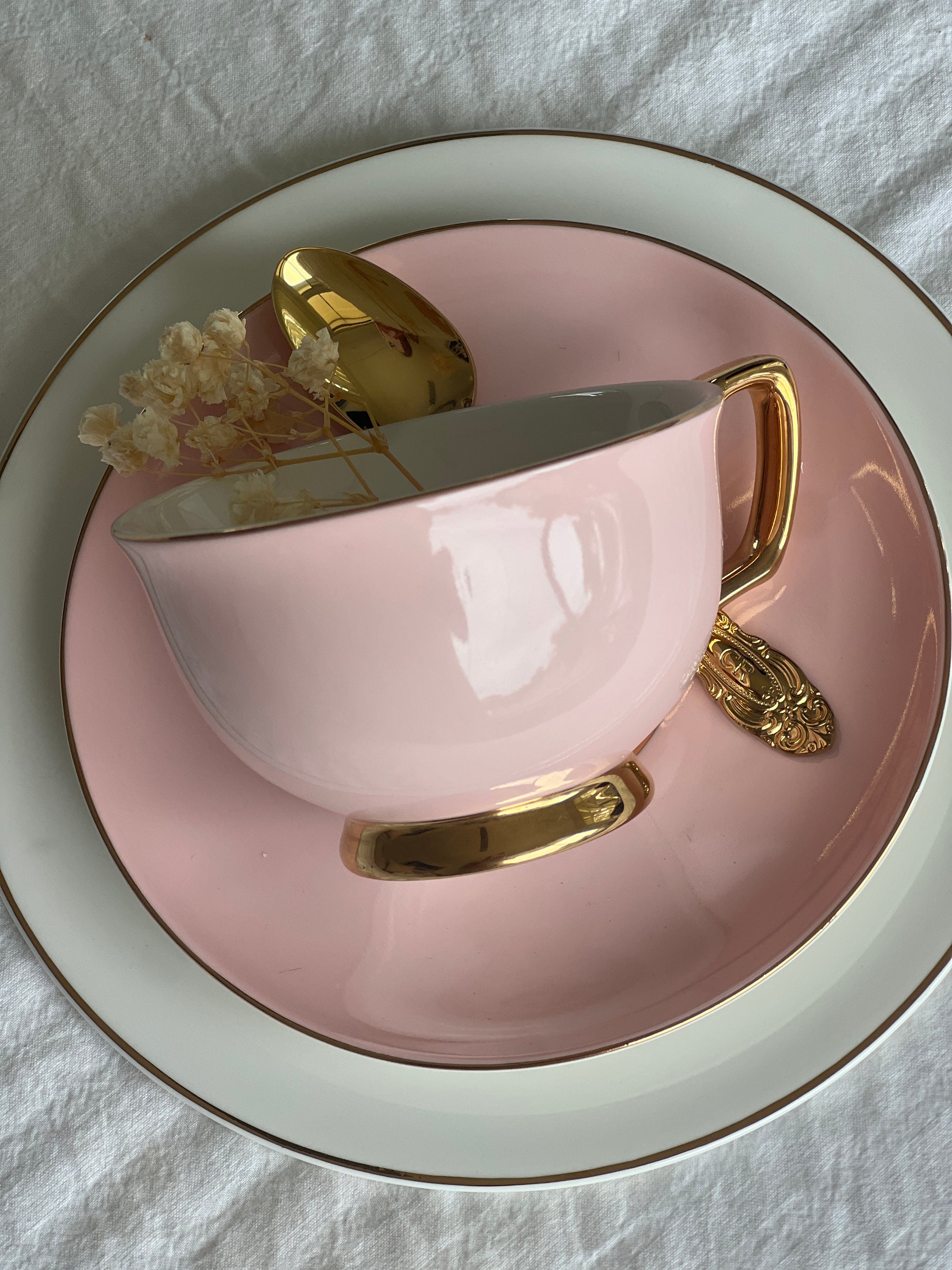 Blush pink porcelain teacup and saucer with gold detailing