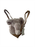 Load image into Gallery viewer, Comfortable-beige coloured, fluffy plush elephant head with a long snuggle nose and floppy ears resting adorably on its paws, sitting propped up in a natural, brown hessian jute bag
