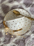 Load image into Gallery viewer, Cristina Re gold polka dot teacup and saucer from the Skye Giraffe Mum and Bub Hamper.
